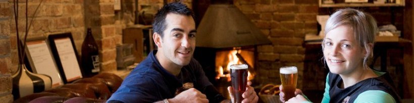 a couple drinking beer in front of a fire, food and wine, Beechworth