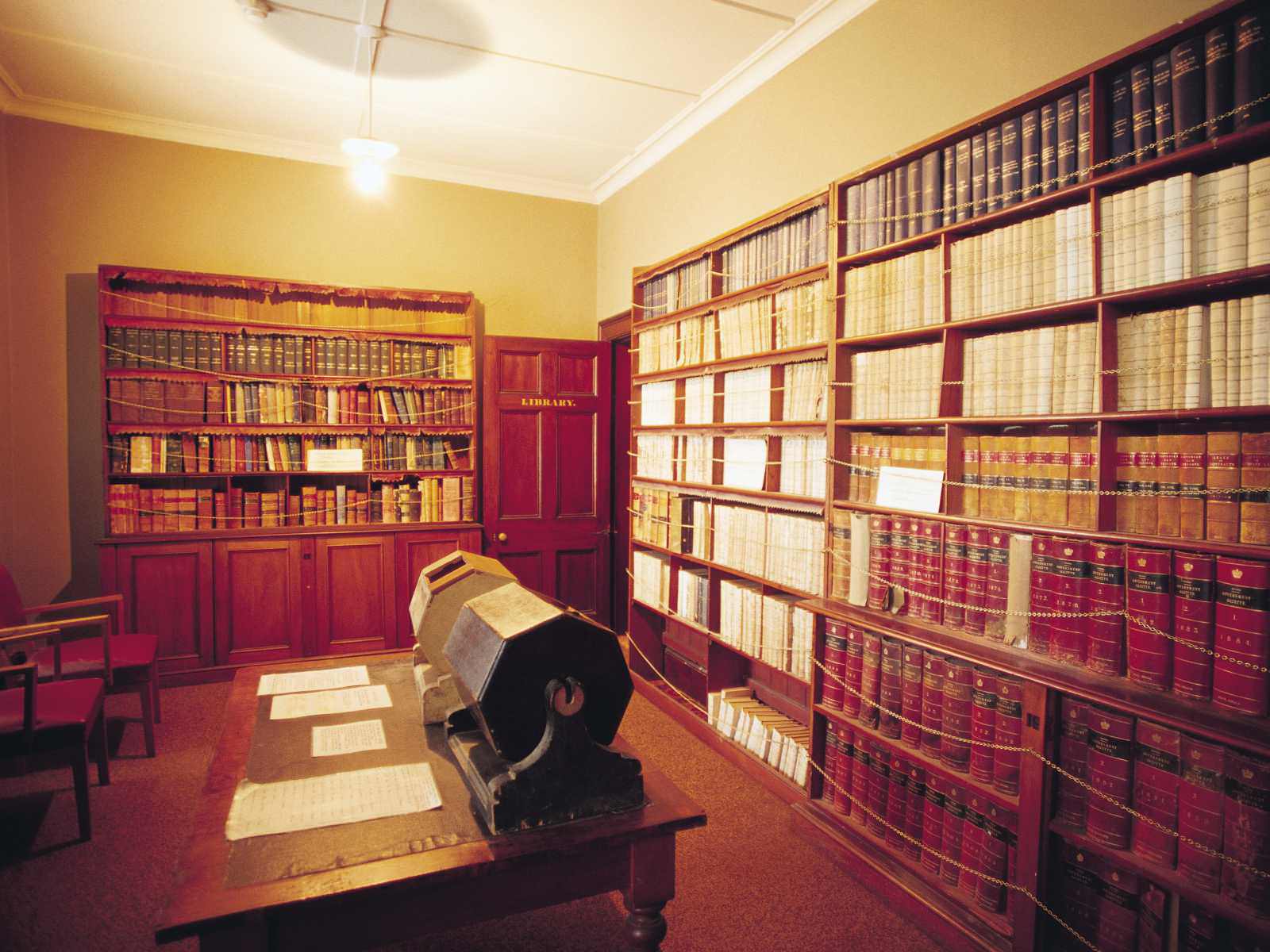 Court House office Beechworth. The room is red with books on the shelf