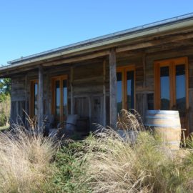 A view of the front of the Traviarti Winery with a barrel under the verandah.